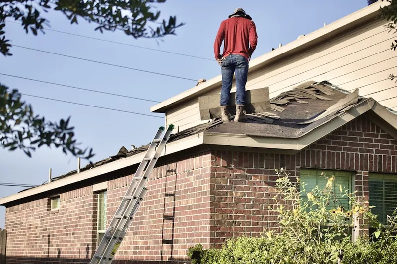 Professional roofer working on a residential roof in Fayetteville